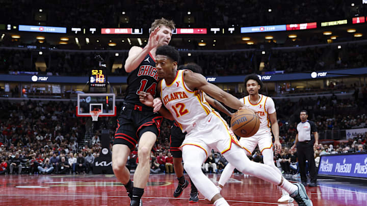 Nov 22, 2024; Chicago, Illinois, USA; Atlanta Hawks forward De'Andre Hunter (12) drives to the basket against Chicago Bulls forward Matas Buzelis (14) during the second half at United Center. Mandatory Credit: Kamil Krzaczynski-Imagn Images