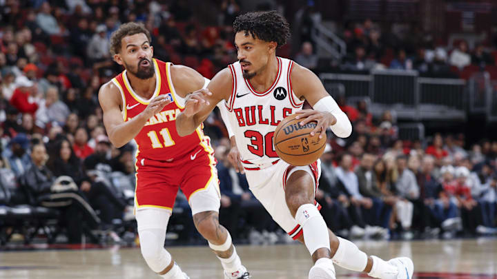 Oct 27, 2025; Chicago, Illinois, USA; Chicago Bulls guard Tre Jones (30) drives to the basket against Atlanta Hawks guard Trae Young (11) during the first half at United Center. Mandatory Credit: Kamil Krzaczynski-Imagn Images