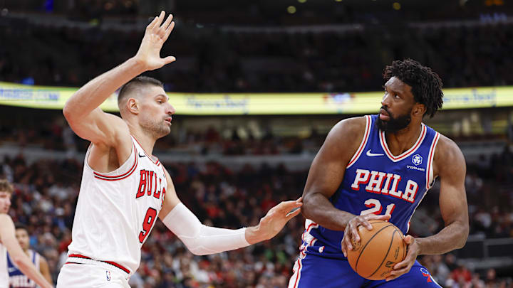 Nov 4, 2025; Chicago, Illinois, USA; Chicago Bulls center Nikola Vucevic (9) defends against Philadelphia 76ers center Joel Embiid (21) during the second half at United Center. Mandatory Credit: Kamil Krzaczynski-Imagn Images