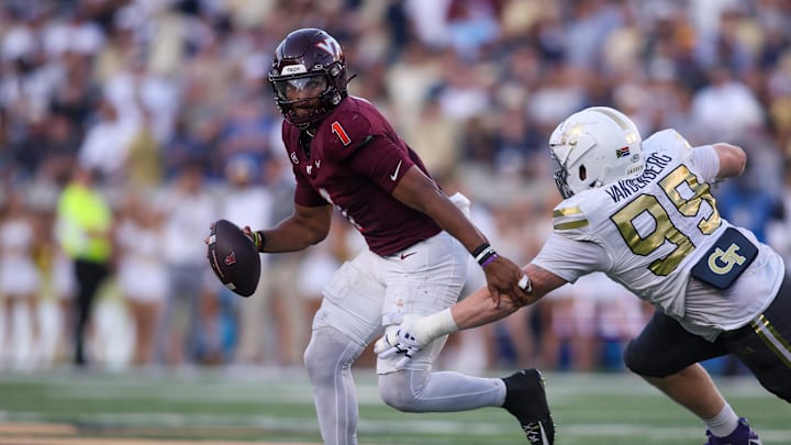 Oct 11, 2025; Atlanta, Georgia, USA; Virginia Tech Hokies quarterback Kyron Drones (1) runs past Georgia Tech Yellow Jackets defensive tackle Jordan van den Berg (99) in the fourth quarter at Bobby Dodd Stadium at Hyundai Field. Mandatory Credit: Brett Davis-Imagn Images Oct 11, 2025; Atlanta, Georgia, USA; Virginia Tech Hokies quarterback Kyron Drones (1) runs past Georgia Tech Yellow Jackets defensive tackle Jordan van den Berg (99) in the fourth quarter at Bobby Dodd Stadium at Hyundai Field. Mandatory Credit: Brett Davis-Imagn Images