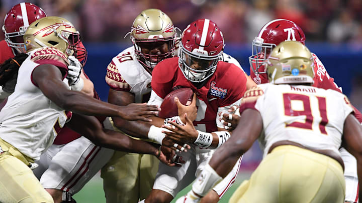 Sep 2, 2017; Atlanta, GA, USA; Alabama Crimson Tide quarterback Jalen Hurts (2) is tackled by Florida State Seminoles defensive tackle Demarcus Christmas (90) in the first quarter at Mercedes-Benz Stadium. Mandatory Credit: John David Mercer-Imagn Images