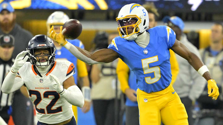 Dec 19, 2024; Inglewood, California, USA;  Los Angeles Chargers wide receiver Joshua Palmer (5) can’t hang on the the ball as he is defended by Denver Broncos safety Brandon Jones (22) in the first half at SoFi Stadium