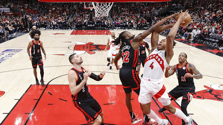 Jan 30, 2024; Chicago, Illinois, USA; Toronto Raptors forward Scottie Barnes (4) goes to the basket against Chicago Bulls guard Ayo Dosunmu (12) during the second half at United Center. Mandatory Credit: Kamil Krzaczynski-Imagn Images