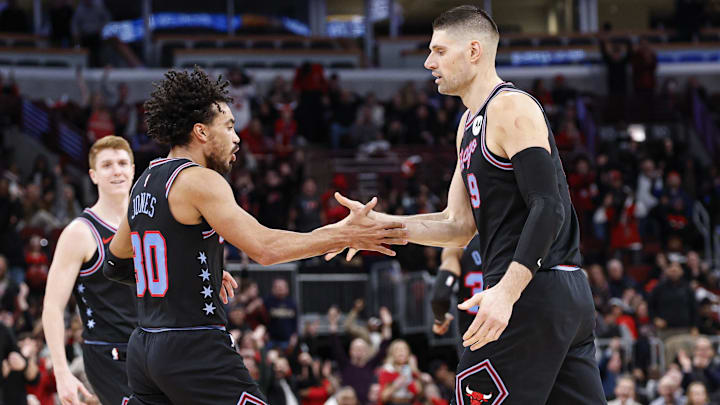 Jan 14, 2026; Chicago, Illinois, USA; Chicago Bulls center Nikola Vucevic (9) celebrates with guard Tre Jones (30) after scoring against the Utah Jazz during the second half at United Center. Mandatory Credit: Kamil Krzaczynski-Imagn Images