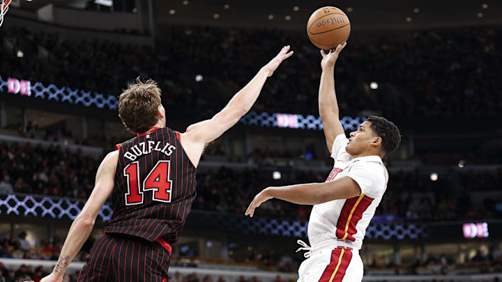 Nov 21, 2025; Chicago, Illinois, USA; Miami Heat guard Dru Smith (12) shoots against Chicago Bulls forward Matas Buzelis (14) during the second half at United Center. Mandatory Credit: Kamil Krzaczynski-Imagn Images