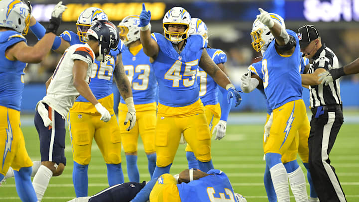 Los Angeles Chargers linebacker Tuli Tuipulotu signals after a fumble recovery against the Denver Broncos at SoFi Stadium. Los Angeles Chargers linebacker Tuli Tuipulotu signals after a fumble recovery against the Denver Broncos at SoFi Stadium.