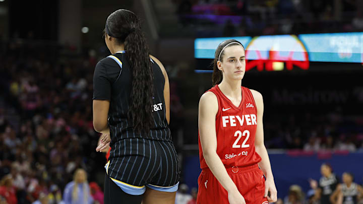 Aug 30, 2024; Chicago, Illinois, USA; Indiana Fever guard Caitlin Clark (22) walks by Chicago Sky forward Angel Reese (5) during the second half at Wintrust Arena. Mandatory Credit: Kamil Krzaczynski-Imagn Images
