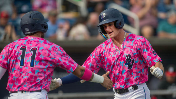 Blue Wahoos' Griffin Conine is greeted at home plate by Will Banfiedl (11) after hitting a home run in the second inning during play against the Birmingham Barons Sunday, April 23, 2023 at Blue Wahoos Stadium.