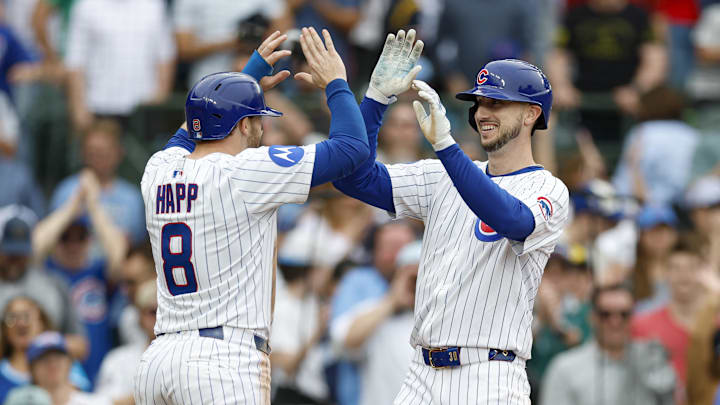 Apr 18, 2025; Chicago, Illinois, USA; Chicago Cubs outfielder Kyle Tucker (30) celebrates with outfielder Ian Happ (8) after hitting a two-run home run against the Arizona Diamondbacks during the eighth inning at Wrigley Field. 