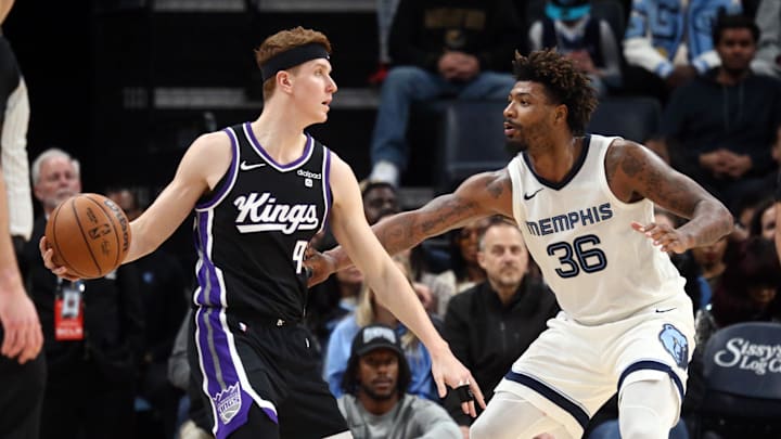 Dec 31, 2023; Memphis, Tennessee, USA; Sacramento Kings guard Kevin Huerter (9) dribbles as Memphis Grizzlies guard Marcus Smart (36) defends during the second half at FedExForum. 