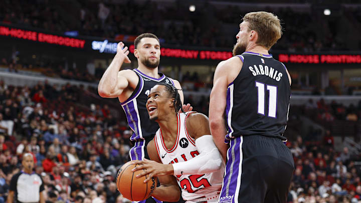 Oct 29, 2025; Chicago, Illinois, USA; Chicago Bulls forward Isaac Okoro (35) goes to the basket against Sacramento Kings guard Zach LaVine (8) and forward Domantas Sabonis (11) during the first half at United Center. Mandatory Credit: Kamil Krzaczynski-Imagn Images
