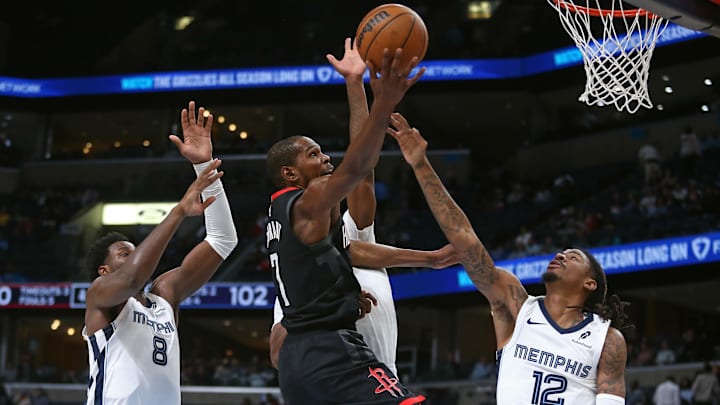 Nov 5, 2025; Memphis, Tennessee, USA; Houston Rockets forward Kevin Durant (7) shoots as Memphis Grizzlies forward/center Jaren Jackson Jr. (8), forward Cedric Coward (23) and guard Ja Morant (12) defend during the fourth quarter at FedExForum. Mandatory Credit: Petre Thomas-Imagn Images