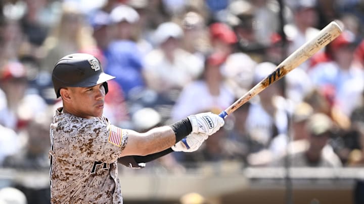 Aug 3, 2025; San Diego, California, USA; San Diego Padres catcher Freddy Fermin (54) hits a single during the seventh inning against the St. Louis Cardinals at Petco Park. Mandatory Credit: Denis Poroy-Imagn Images
