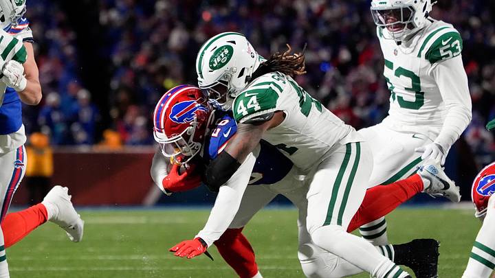 Jan 4, 2026; Orchard Park, New York, USA; New York Jets linebacker Jamien Sherwood (44) tackles Buffalo Bills running back Ty Johnson (26) during the third quarter at Highmark Stadium. Mandatory Credit: Gregory Fisher-Imagn Images