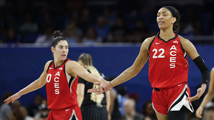 Aug 25, 2024; Chicago, Illinois, USA; Las Vegas Aces center A'ja Wilson (22) is congratulated by guard Kelsey Plum (10) after scoring against the Chicago Sky during the first half at Wintrust Arena. Mandatory Credit: Kamil Krzaczynski-Imagn Images