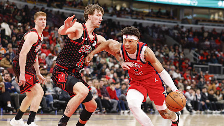 Dec 14, 2025; Chicago, Illinois, USA; New Orleans Pelicans guard Jeremiah Fears (0) drives to the basket against Chicago Bulls forward Matas Buzelis (14) during the second half at United Center. Mandatory Credit: Kamil Krzaczynski-Imagn Images