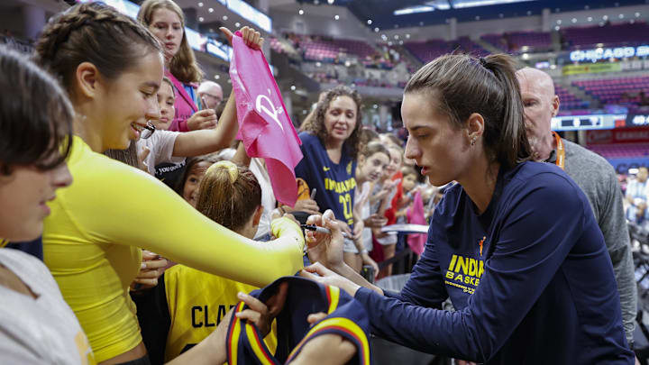 Aug 30, 2024; Chicago, Illinois, USA; Indiana Fever guard Caitlin Clark (22) signs autographs before a basketball game against the Chicago Sky at Wintrust Arena. Mandatory Credit: Kamil Krzaczynski-Imagn Images