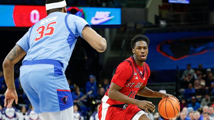 Feb 3, 2026; Chicago, Illinois, USA; St. John's Red Storm guard Ian Jackson (11) drives to the basket against DePaul Blue Demons forward N.J. Benson (35) during the first half at Wintrust Arena. Mandatory Credit: Kamil Krzaczynski-Imagn Images