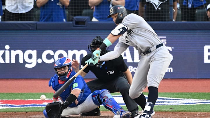 Oct 4, 2025; Toronto, Ontario, CAN; New York Yankees right fielder Aaron Judge (99) strikes out in front of Toronto Blue Jays catcher Alejandro Kirk (30) in the sixth inning during game one of the ALDS round for the 2025 MLB playoffs at Rogers Centre. Mandatory Credit: Dan Hamilton-Imagn Images