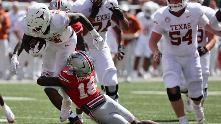 Aug 30, 2025; Columbus, Ohio, USA; Texas Longhorns running back CJ Baxter (4) rushes the ball against the Ohio State Buckeyes in the first half at Ohio Stadium. Mandatory Credit: Joseph Maiorana-Imagn Images