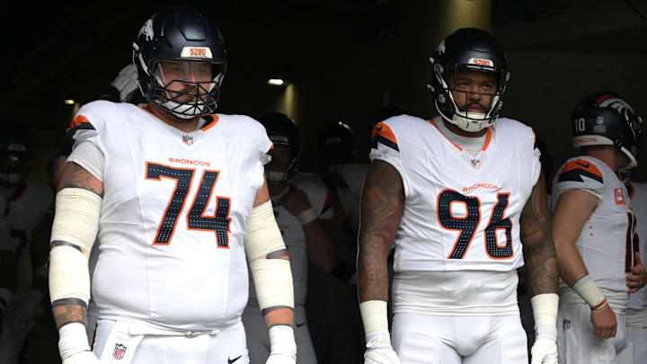 Sep 21, 2025; Inglewood, California, USA;  Denver Broncos guard Ben Powers (74) and defensive tackle Eyioma Uwazurike (96) wait to enter the field for the game against the Los Angeles Chargers at SoFi Stadium. 