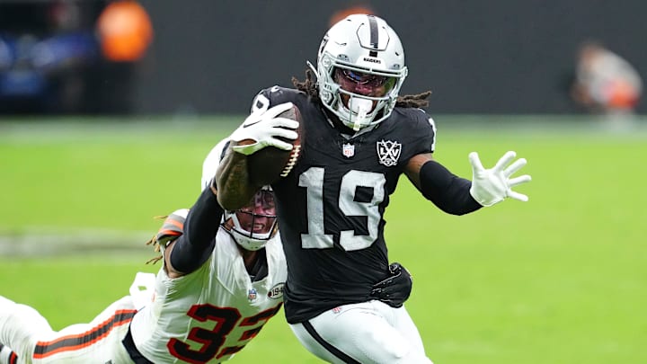 Sep 29, 2024; Paradise, Nevada, USA; Las Vegas Raiders wide receiver DJ Turner (19) evades the tackle of Cleveland Browns safety Ronnie Hickman (33) to score a touchdown during the third quarter at Allegiant Stadium. Mandatory Credit: Stephen R. Sylvanie-Imagn Images