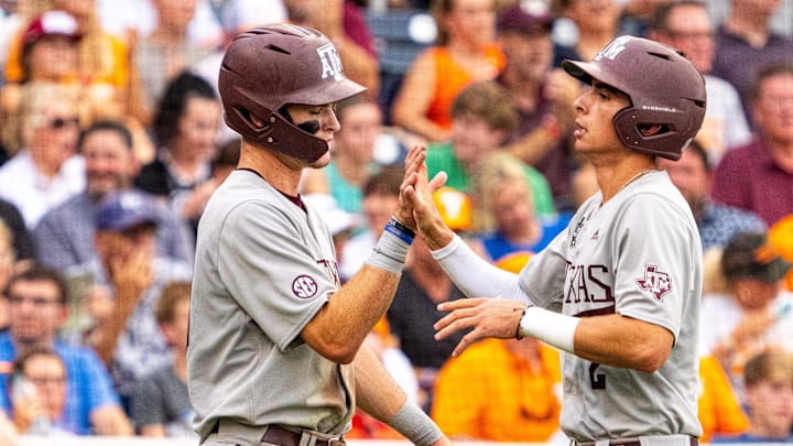 Jun 22, 2024; Omaha, NE, USA; Texas A&M Aggies shortstop Ali Camarillo (2) and left fielder Caden Sorrell (13) celebrate after scoring runs against the Tennessee Volunteers during the third inning at Charles Schwab Field Omaha. Mandatory Credit: Dylan Widger-Imagn Images