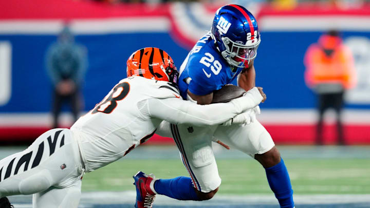 New York Giants running back Tyrone Tracy Jr. (29) runs for a first down in the third quarter against Cincinnati Bengals defensive end Joseph Ossai (58), Sunday, October 13, 2024, in East Rutherford.