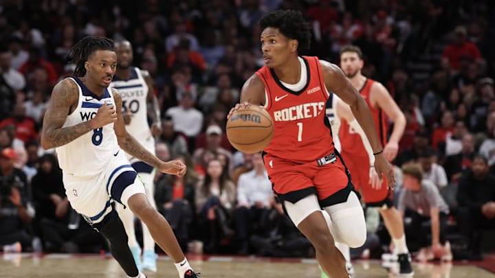 Jan 16, 2026; Houston, Texas, USA; Houston Rockets guard Amen Thompson (1) dribbles against Minnesota Timberwolves guard Bones Hyland (8) in the second half at Toyota Center. Mandatory Credit: Thomas Shea-Imagn Images