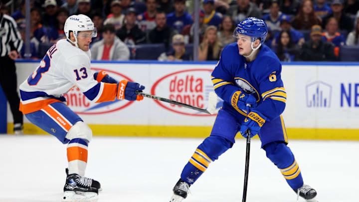 Mar 31, 2026; Buffalo, New York, USA;  Buffalo Sabres left wing Zach Benson (6) looks to pass as New York Islanders center Mathew Barzal (13) defends during the second period at KeyBank Center. Mandatory Credit: Timothy T. Ludwig-Imagn Images