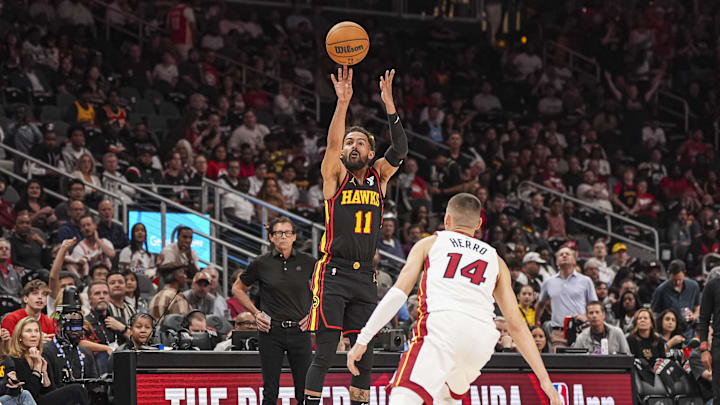 Apr 18, 2025; Atlanta, Georgia, USA; Atlanta Hawks guard Trae Young (11) shoots over Miami Heat guard Tyler Herro (14) during the first half at State Farm Arena. Mandatory Credit: Dale Zanine-Imagn Images