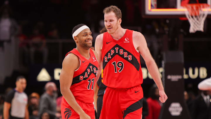 Jan 23, 2025; Atlanta, Georgia, USA; Toronto Raptors forward Bruce Brown (11) and center Jakob Poeltl (19) celebrate after a victory over the Atlanta Hawks at State Farm Arena. Mandatory Credit: Brett Davis-Imagn Images