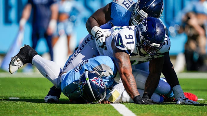 Seattle Seahawks defensive tackle Byron Murphy II (91) sacks Tennessee Titans quarterback Cam Ward (1) during the second quarter at Nissan Stadium in Nashville, Tenn., Sunday, Nov. 23, 2025.