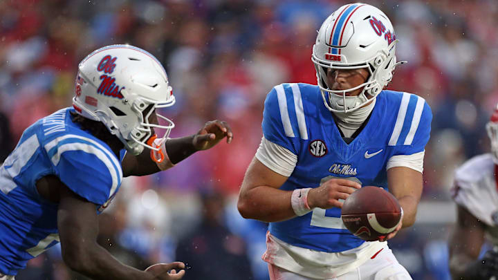Nov 9, 2024; Oxford, Mississippi, USA; Mississippi Rebels quarterback Jaxson Dart (2) hands the ball off to running back Ulysses Bentley IV (24) during the first half against the Georgia Bulldogs at Vaught-Hemingway Stadium. Mandatory Credit: Petre Thomas-Imagn Images