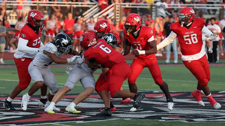 Lakota West defender Roman Combs (6) takes the ball from Lakota East quarterback Nile Knutson and returns it for a touchdown during the Firebirds' 48-18 Week 2 victory.