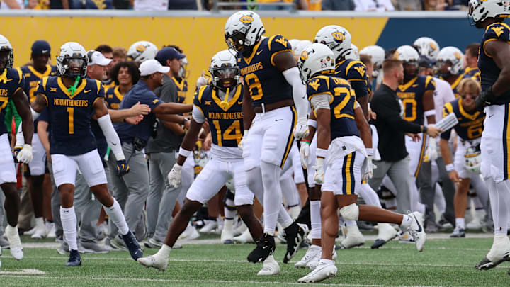 West Virginia University SPUR Tyrin Bradley (8) celebrates after intercepting a pass against Kansas in the first quarter. 
