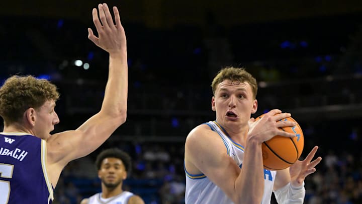Feb 7, 2026; Los Angeles, California, USA;  UCLA Bruins forward Tyler Bilodeau (34) is defended by Washington Huskies forward Hannes Steinbach (6) as he drives to the basket in the first half at Pauley Pavilion presented by Wescom Financial. Mandatory Credit: Jayne Kamin-Oncea-Imagn Images