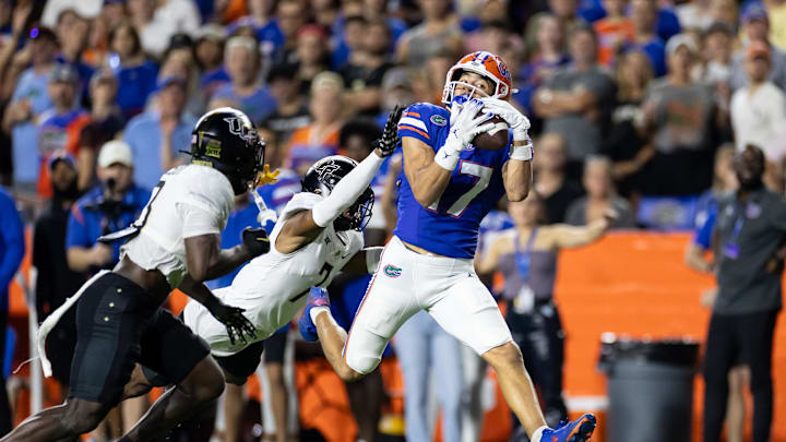 Oct 5, 2024; Gainesville, Florida, USA; Florida Gators wide receiver Chimere Dike (17) makes a catch over UCF Knights defensive back Antione Jackson (7) during the first half at Ben Hill Griffin Stadium. Mandatory Credit: Matt Pendleton-Imagn Images