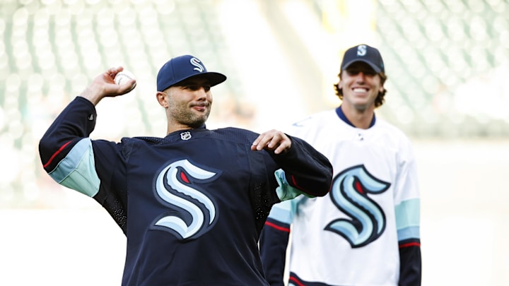 Jul 22, 2021; Seattle, Washington, USA; Seattle Kraken defenseman Mark Giordano, left, throws out the first pitch before a game between the Seattle Mariners and Oakland Athletics at T-Mobile Park. Mandatory Credit: Joe Nicholson-Imagn Images