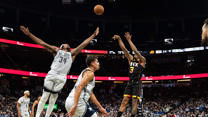 Dec 8, 2024; Orlando, Florida, USA; Phoenix Suns guard Bradley Beal (3) shoots the ball over Orlando Magic forward Wendell Carter Jr. in the third quarter at Kia Center. Mandatory Credit: Jeremy Reper-Imagn Images