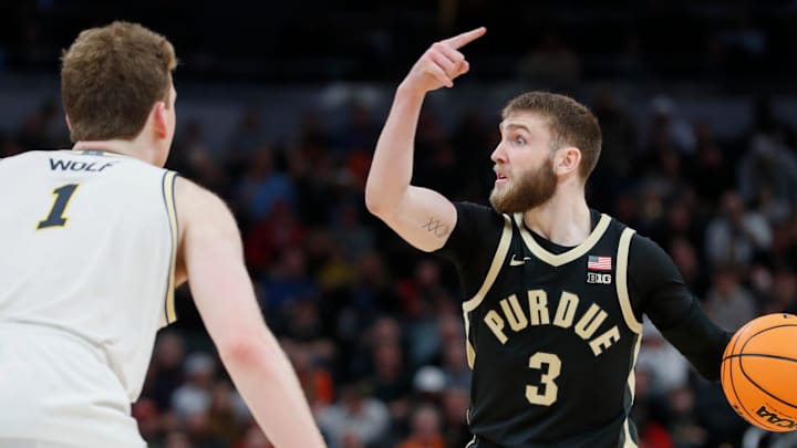 Purdue Boilermakers guard Braden Smith (3) is defended by Michigan Wolverines center Danny Wolf (1) Friday, March 14, 2025, during the Big Ten Men’s Basketball Tournament game at Gainbridge Fieldhouse in Indianapolis. Michigan Wolverines won 86-68.