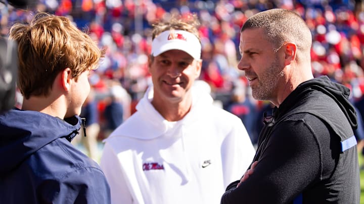 Florida Gators head coach Billy Napier talks with Mississippi Rebels head coach Lane Kiffin before the start of the game at Ben Hill Griffin Stadium in Gainesville, FL on Saturday, November 23, 2024. [Doug Engle/Gainesville Sun]