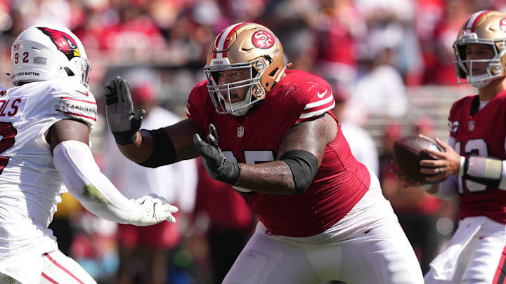 Oct 6, 2024; Santa Clara, California, USA; San Francisco 49ers guard Aaron Banks (center) blocks against Arizona Cardinals defensive tackle Bilal Nichols (left) during the second quarter at Levi's Stadium. Mandatory Credit: Darren Yamashita-Imagn Images