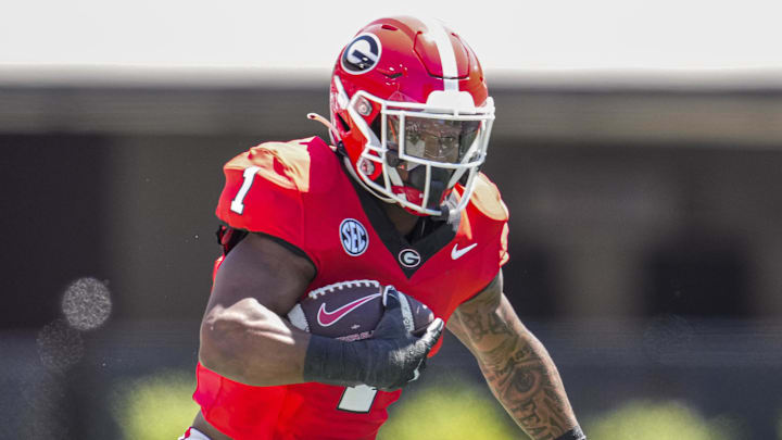 Georgia Bulldogs running back Trevor Etienne (1) runs with the ball during a college football game.