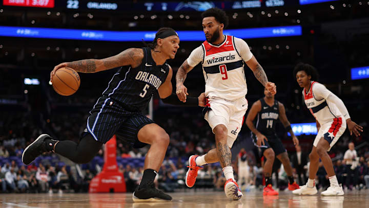 Orlando Magic forward Paolo Banchero (5) drives to the basket as Washington Wizards forward Justin Champagnie (9) defends in the first half at Capital One Arena.  Geoff Burke-Imagn Images
