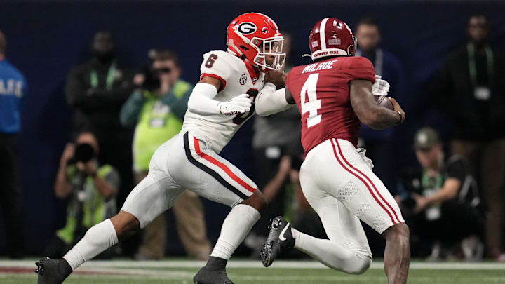 Dec 2, 2023; Atlanta, GA, USA; Georgia Bulldogs defensive back Daylen Everette (6) makes a tackle on Alabama Crimson Tide quarterback Jalen Milroe (4) during the first half in the SEC Championship game at Mercedes-Benz Stadium. Mandatory Credit: Dale Zanine-Imagn Images