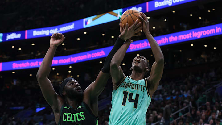 Apr 13, 2025; Boston, Massachusetts, USA; Boston Celtics center Neemias Queta (88) fouls Charlotte Hornets forward Moussa Diabate (14) during the second half at TD Garden. Mandatory Credit: Paul Rutherford-Imagn Images