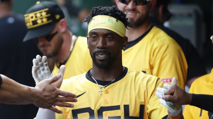 Jun 22, 2024; Pittsburgh, Pennsylvania, USA;  Pittsburgh Pirates designated hitter Andrew McCutchen (22) high-fives in the dugout after scoring a run against theTampa Bay Rays during the third inning at PNC Park. Mandatory Credit: Charles LeClaire-USA TODAY Sports