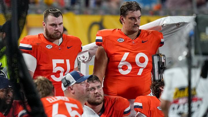 Sep 19, 2026; Charlotte, North Carolina, USA; Virginia Cavaliers offensive line watch a monitor and react to being outscored during the second half by West Virginia Mountaineers at Bank of America Stadium. Mandatory Credit: Jim Dedmon-Imagn Images Sep 19, 2026; Charlotte, North Carolina, USA; Virginia Cavaliers offensive line watch a monitor and react to being outscored during the second half by West Virginia Mountaineers at Bank of America Stadium. Mandatory Credit: Jim Dedmon-Imagn Images