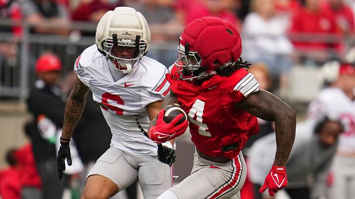 Wide receiver Jeremiah Smith (4) runs for a touchdown past cornerback Devin Sanchez (6) during the Ohio State football spring game at Ohio Stadium in Columbus on April 18, 2026. Wide receiver Jeremiah Smith (4) runs for a touchdown past cornerback Devin Sanchez (6) during the Ohio State football spring game at Ohio Stadium in Columbus on April 18, 2026.